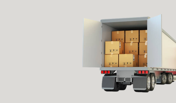 The back of a large white semi-truck with its doors open, revealing a cargo space filled with many stacked cardboard boxes.