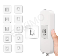 A set of eight transparent adhesive hooks arranged in a grid with a power strip being held by a hand and a hook attached to it.