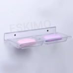 White Eskimo square double soap dish mounted on a wall with a pink and a purple soap bar inside.