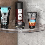 An Eskimo transparent bathroom corner shelf holding several men's grooming products like face wash and shaving spray.