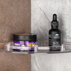 Close-up of a single transparent Eskimo corner shelf holding men's grooming products in a contemporary bathroom.